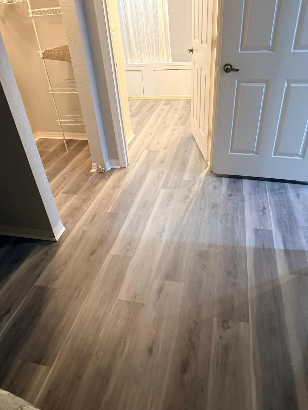 Doorway transition on light gray vinyl plank